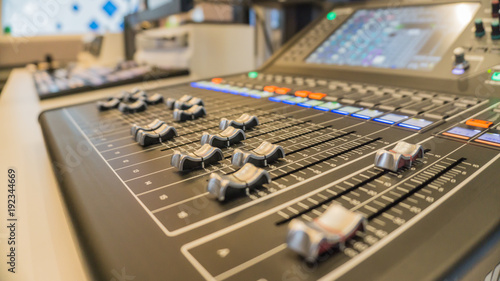 Selective focus buttons equipment for sound mixer control with blurry background., in live studio for broadcasting.