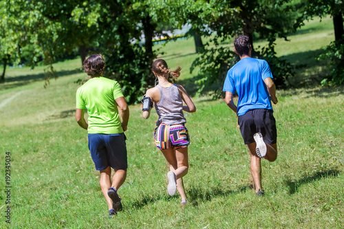 Woman and two young men running in the park © BGStock72
