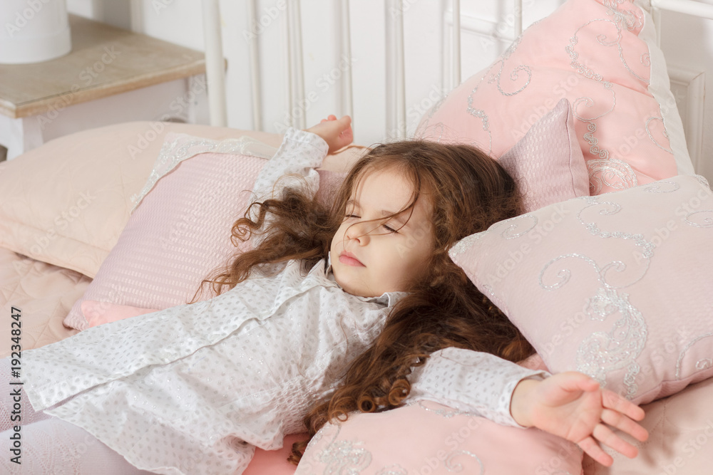 Little kid girl sleeping in a pink bed at home and watching dreams. Little kid girl sleeping in a pink bed at home and watching dreams.