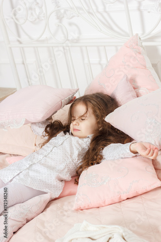 Little kid girl sleeping in...