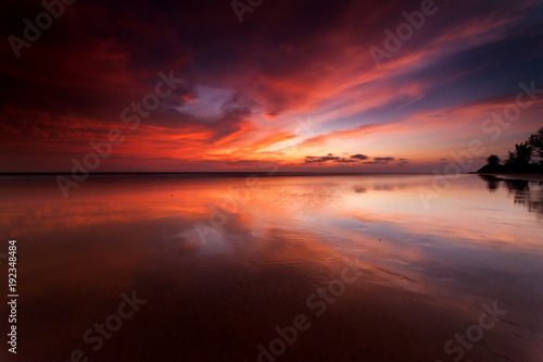beautiful sunset colors with reflection. image contain soft focus due to long expose. © udoikel09