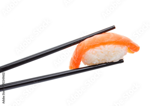 Japanese cuisine. Sushi nigiri in chopsticks isolated on white background background.