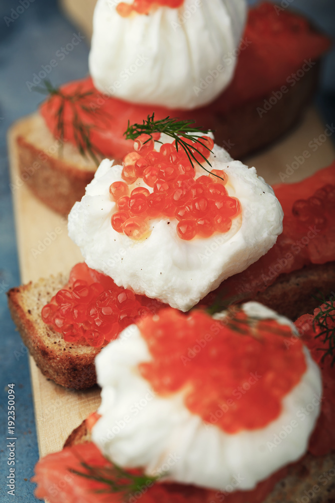 Delicious sandwich with egg - poached, caviar and red fish Delicious sandwich with egg - poached, caviar and red fish