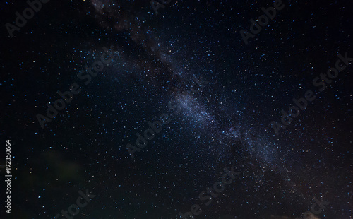 starry night and milky way galaxy night photograph. image contain soft  focus, blur and noise due to long expose and high iso.
