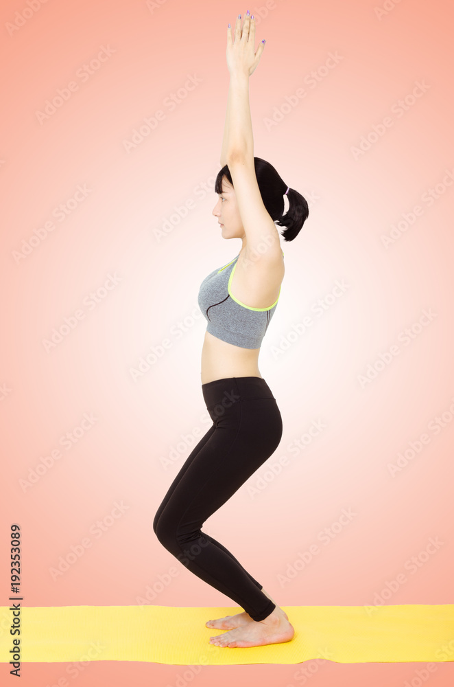 attractive woman stand practice yoga pose in orange background with clipping path.