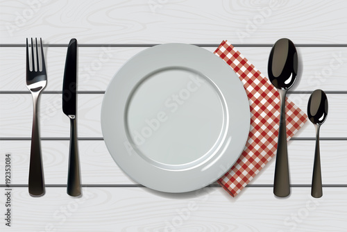 Empty realistic plate with spoon, knife and fork on a wooden background with red napkin. Cutlery on a wood table. For cafe and restaurant design