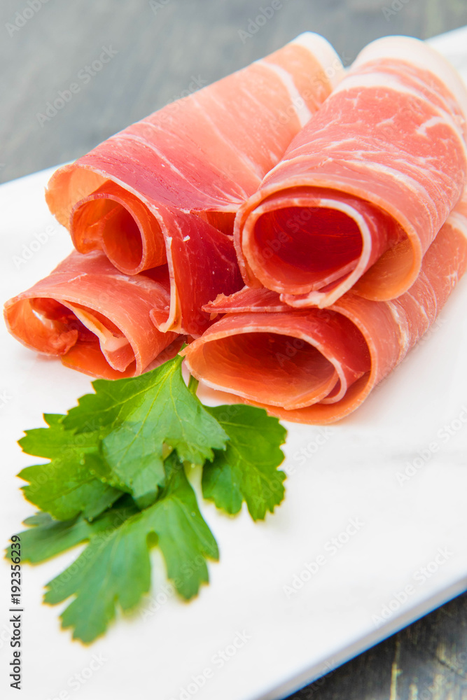 marble dish with raw ham slices