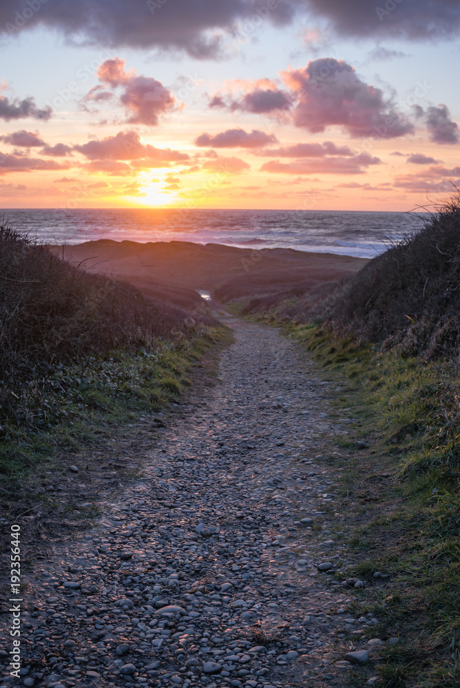 Path leading to the ocean at sunset