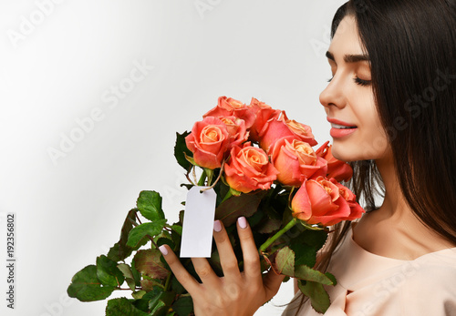 Beautiful woman with bouquet roses flowers with empty text copy space