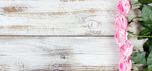 Lovely pink roses for Mothers Day holiday on white rustic wood