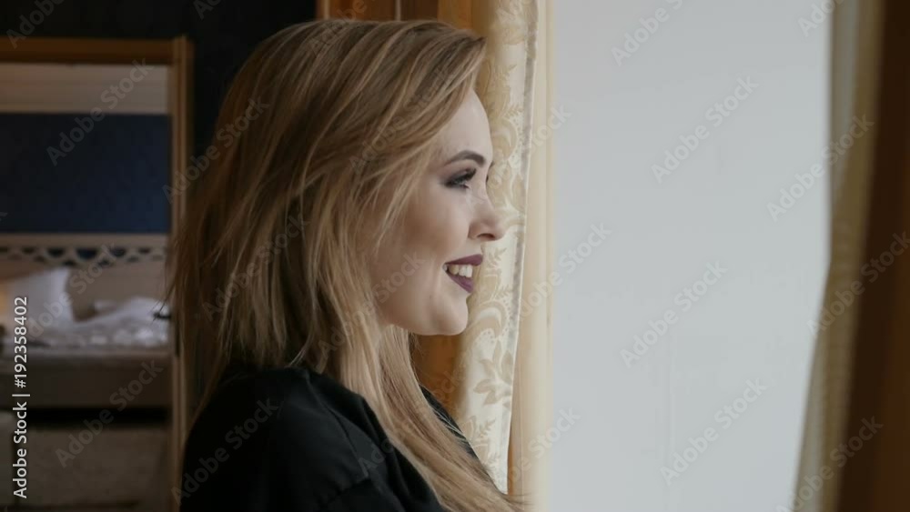 Woman is looking out the window Woman is looking out the window