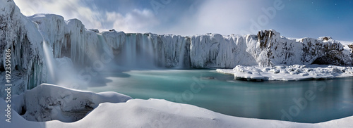 Godafoss frozen waterfall during Winter at sunset. North Iceland photo