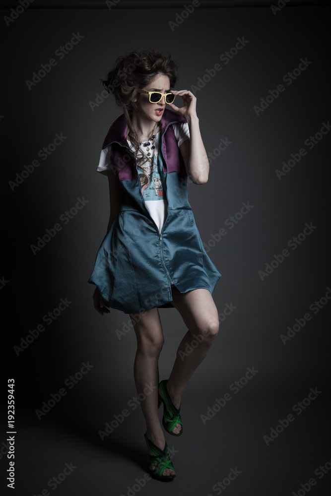 young teen girl posing with sunglasses in studio young teen girl posing with sunglasses in studio