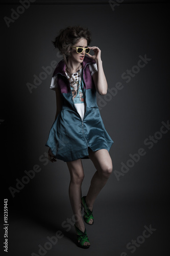 young teen girl posing with sunglasses in studio