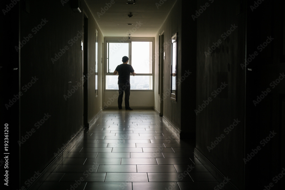 Silhouette of business man sitting alone., Sad and Serious Male sit and hug his knee alone of closeing office.With his reflect shadow. Dramatic moment. sad concept., hurt concept. lonely