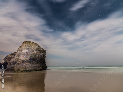 the famous beach of the Cathedrals, spain, under the light of the full moon, on a warm summer night