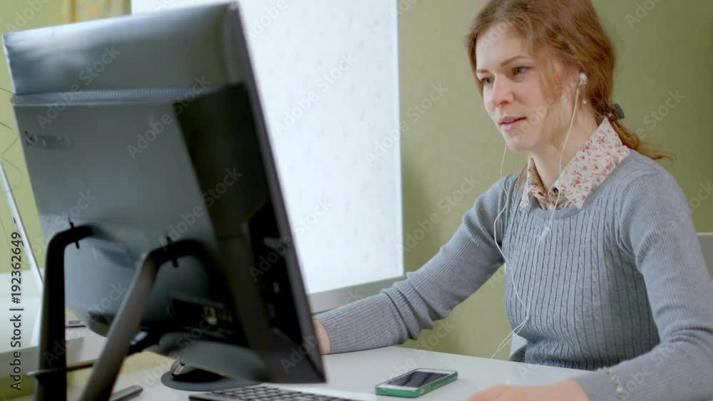 Young pretty business woman with computer and notebook in the home office Young pretty business woman with computer and notebook in the home office