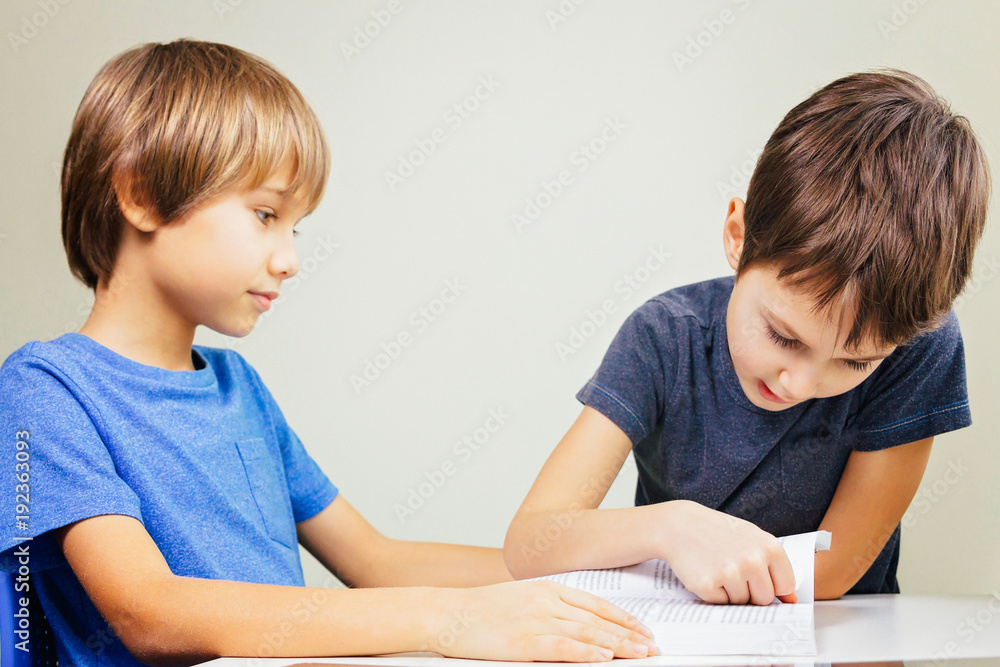Little boy practice reading with his brother at home Little boy practice reading with his brother at home