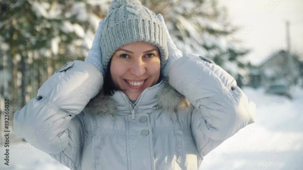 Happy young woman posing for the camera in the suburbs in winter. Happy young woman posing for the camera in the suburbs in winter.
