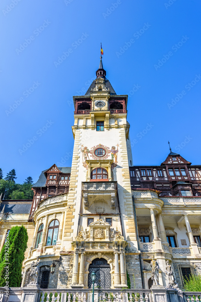Obraz premium Daylight view from bottom to ornamented facade of Peles castle with tower