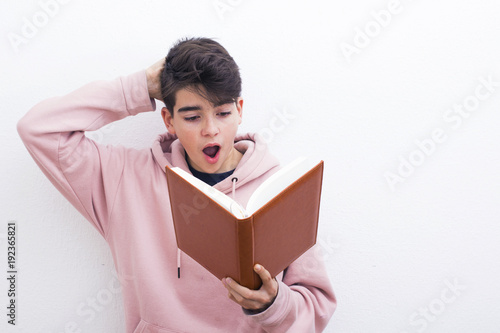adolescent or preadolescent student with book on white background