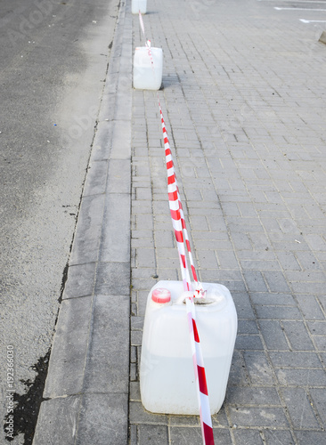 Canisters of water exposed as temporary barriers. The prohibitive tape. photo