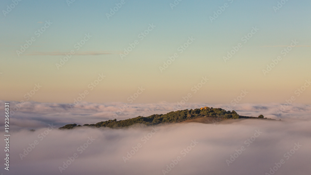 An island above the clouds, Mountain top peaking out of the clouds