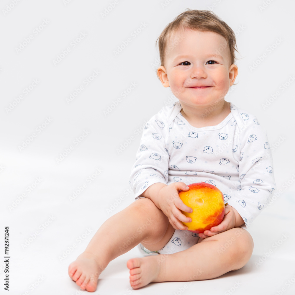 Portrait of a happy little child with an apple in his hands Portrait of a happy little child with an apple in his hands
