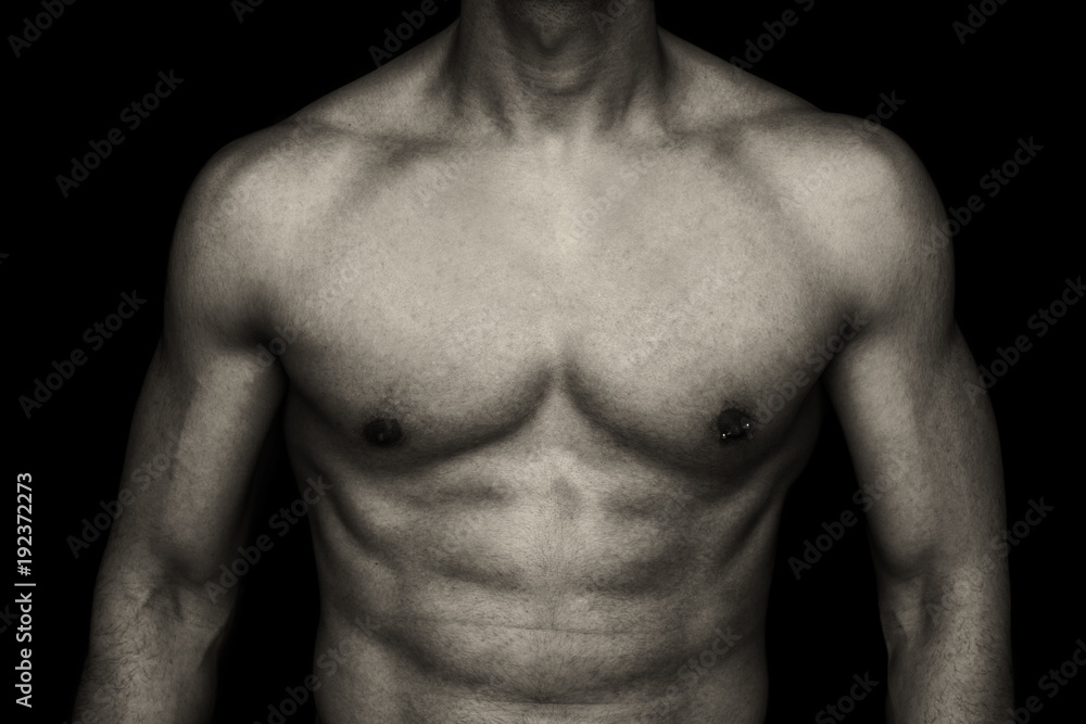 muscle young man on dark background - male body part muscle young man on dark background - male body part