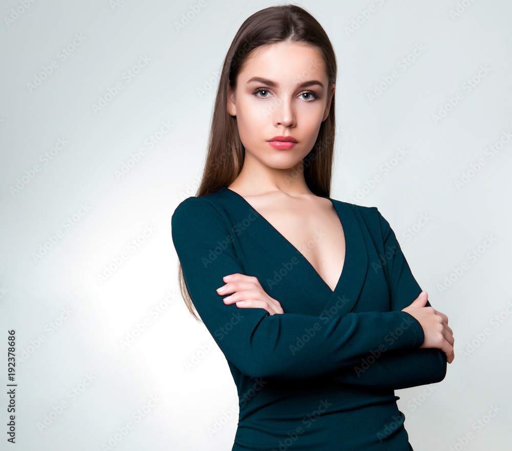 Fototapeta premium beautiful young woman with long hair posing on background with copy space