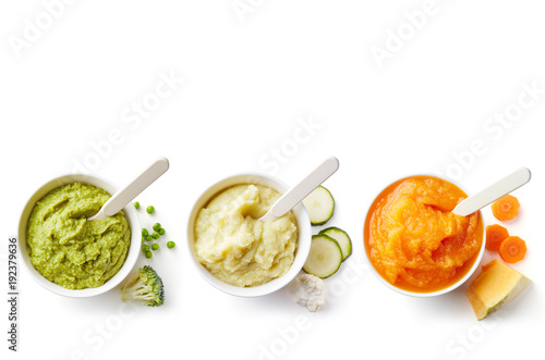 Three bowls of baby puree isolated on white from above