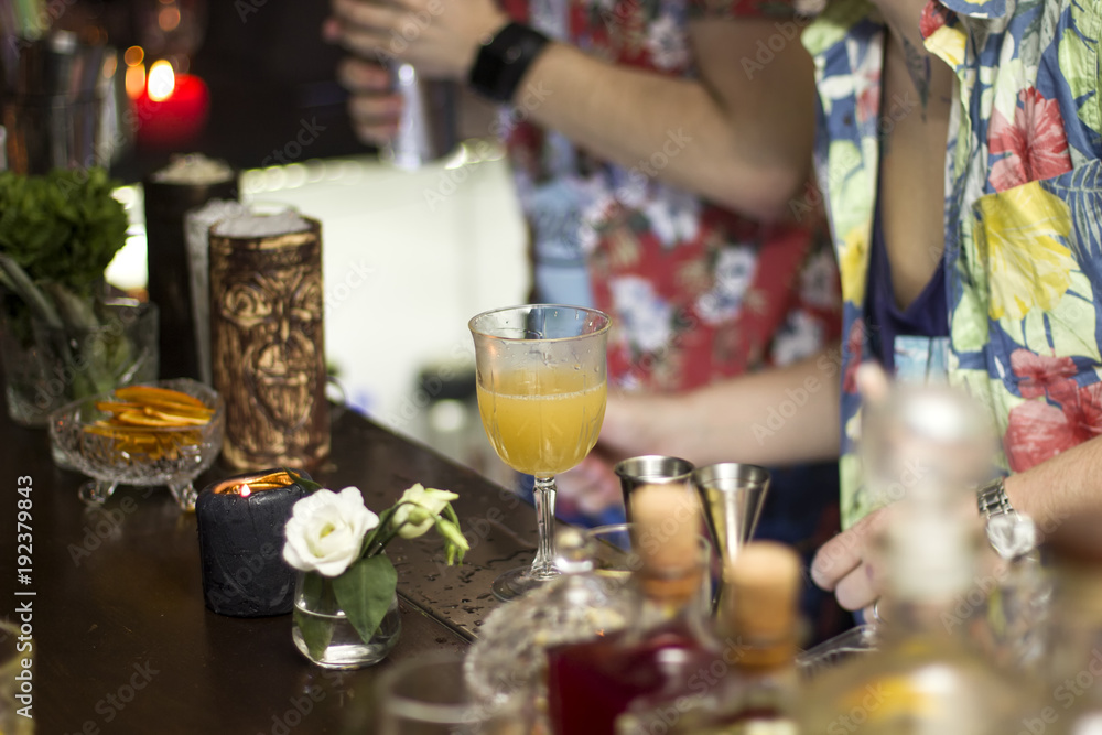 Barmen are working, tropical cocktails