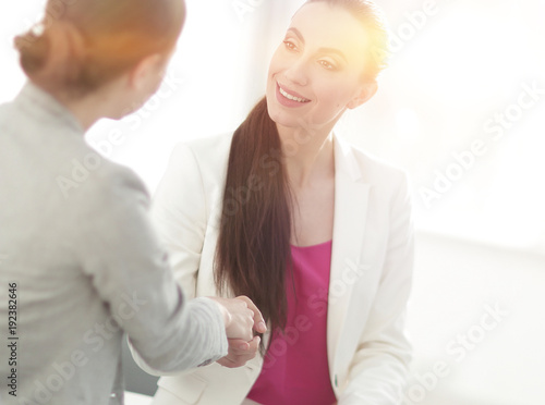 handshake business woman with a client