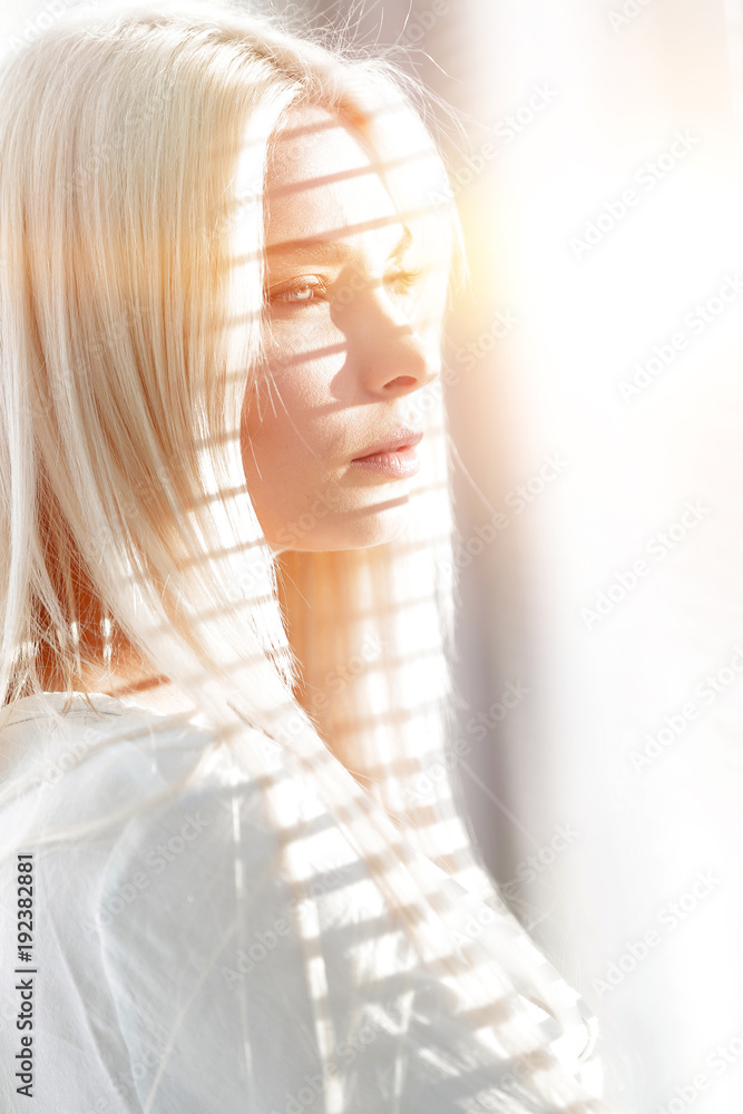 Fototapeta premium Close-up of a pensive young business woman looking out the window