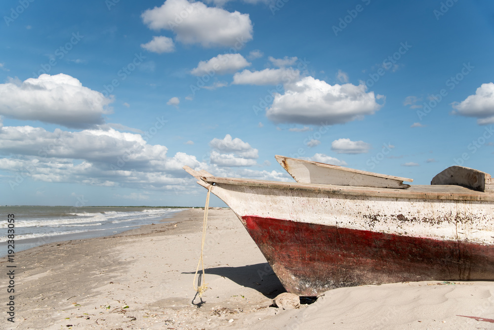 fisherman boat on the sand on a sunny beach. Guajira . Colombia. fisherman boat on the sand on a sunny beach. Guajira . Colombia.