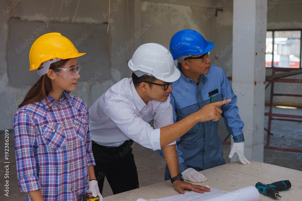 Middle aged Engineer, mechanic and female worker in a meeting. Middle aged Engineer, mechanic and female worker in a meeting.