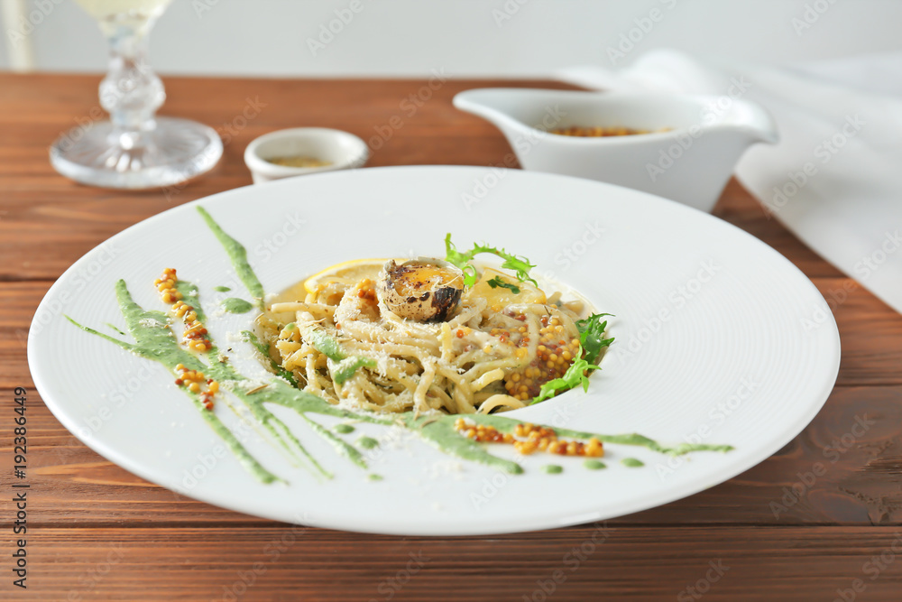 Delicious pasta with egg yolk and sauce on plate Delicious pasta with egg yolk and sauce on plate