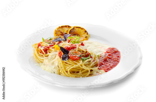 Delicious pasta with tomato sauce and vegetables on plate against white background