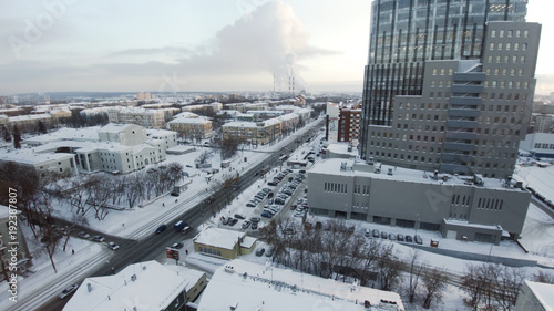 Apartment buildings or blocks of flats covered by snow. Clip. Urban winter landscape with street perspective aerial top view. Clip. The skyscrapers in the city. City life. Amazing city landscape.