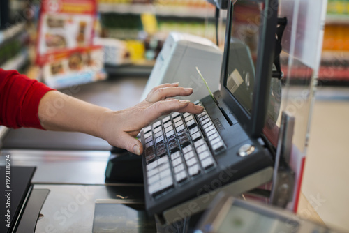 Typing to the cashier at the supermarket photo