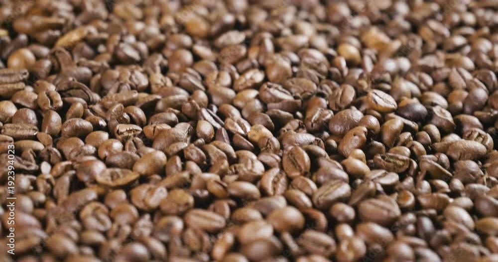 Close-up of a hand touching a handful of coffee beans to smell and consistency. Good quality coffee still hot and steaming. Concept of: relaxation, aroma and perfumes. Close-up of a hand touching a handful of coffee beans to smell and consistency. Good quality coffee still hot and steaming. Concept of: relaxation, aroma and perfumes.