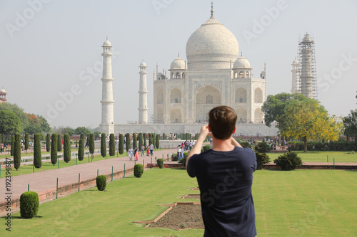 Photography Man taking phone picture of taj mahal