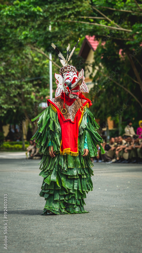 Hudoq; Traditional native ethnic group of Borneo thanksgiving dance wearing mask symbolize thirteen crop-destroying pests and banana leaves costumes