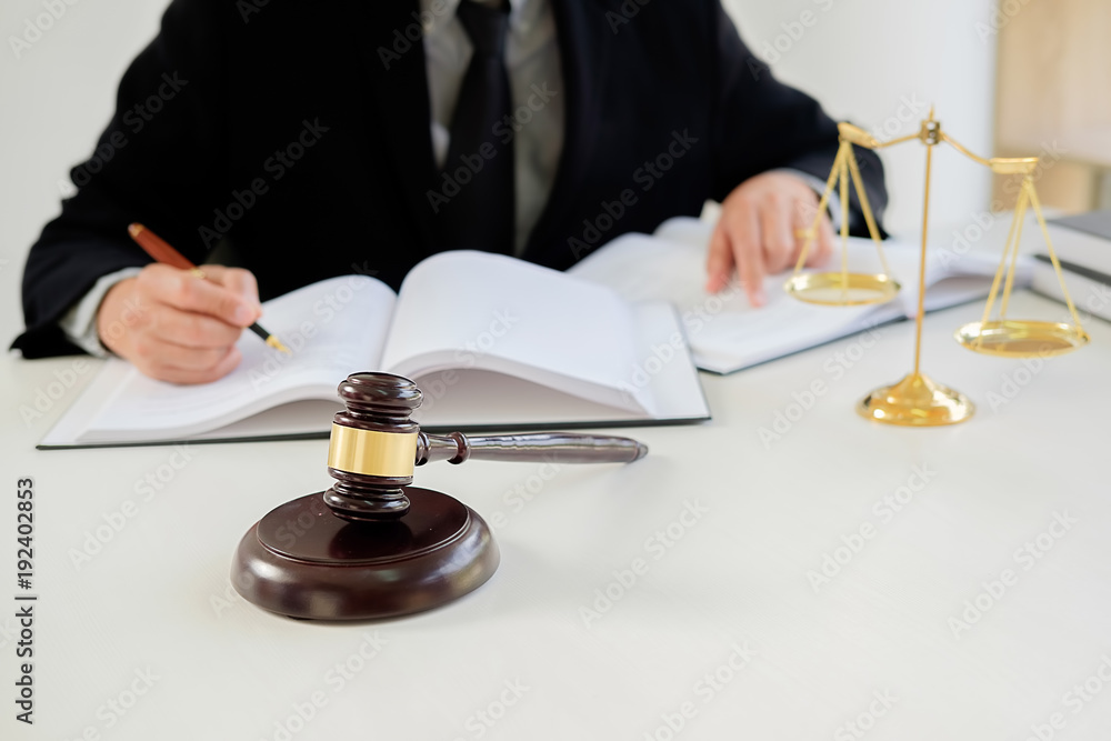 Judge gavel with Justice lawyers having team meeting at law firm in background. Concepts of law. Judge gavel with Justice lawyers having team meeting at law firm in background. Concepts of law.