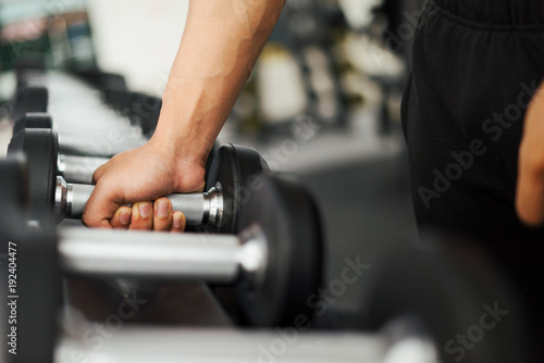 strong fitness man posing muscular body and doing exercises for bodybuilder in the gym, fitness concept, sport concept