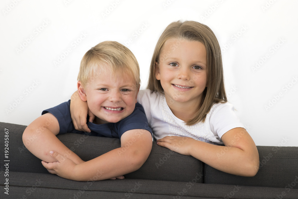 7 years old beautiful little girl posing happy at home sofa couch with her small cute young 3 years old brother in siblings love relationship 7 years old beautiful little girl posing happy at home sofa couch with her small cute young 3 years old brother in siblings love relationship