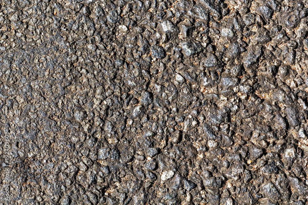 Surface of the old asphalt with the transition from small fractions to large ones. Background texture. Road surface Surface of the old asphalt with the transition from small fractions to large ones. Background texture. Road surface