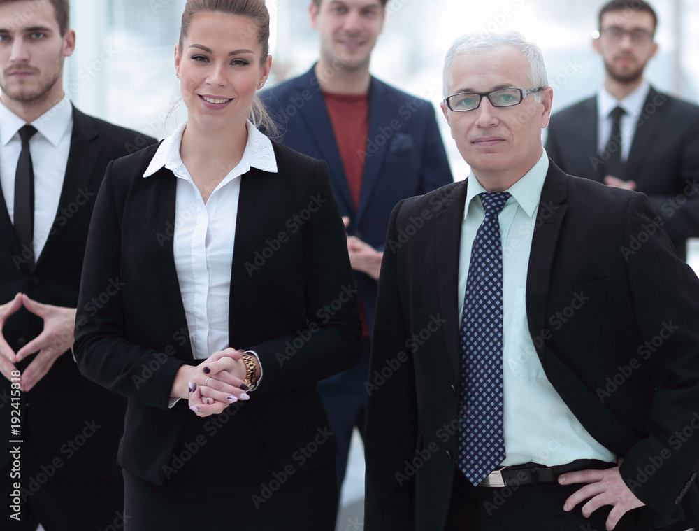 serious businessman and business woman on the background of the office staff. serious businessman and business woman on the background of the office staff.