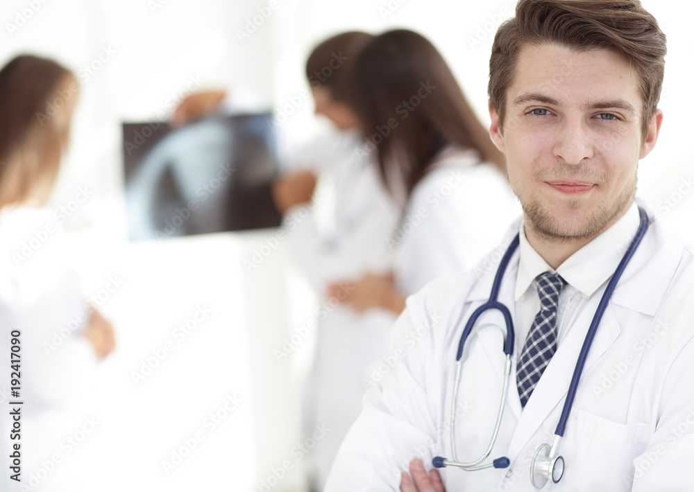 young doctor on the background of colleagues young doctor on the background of colleagues