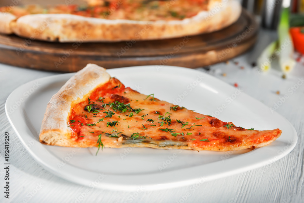 Plate with slice of pizza on table. Fresh from oven Plate with slice of pizza on table. Fresh from oven